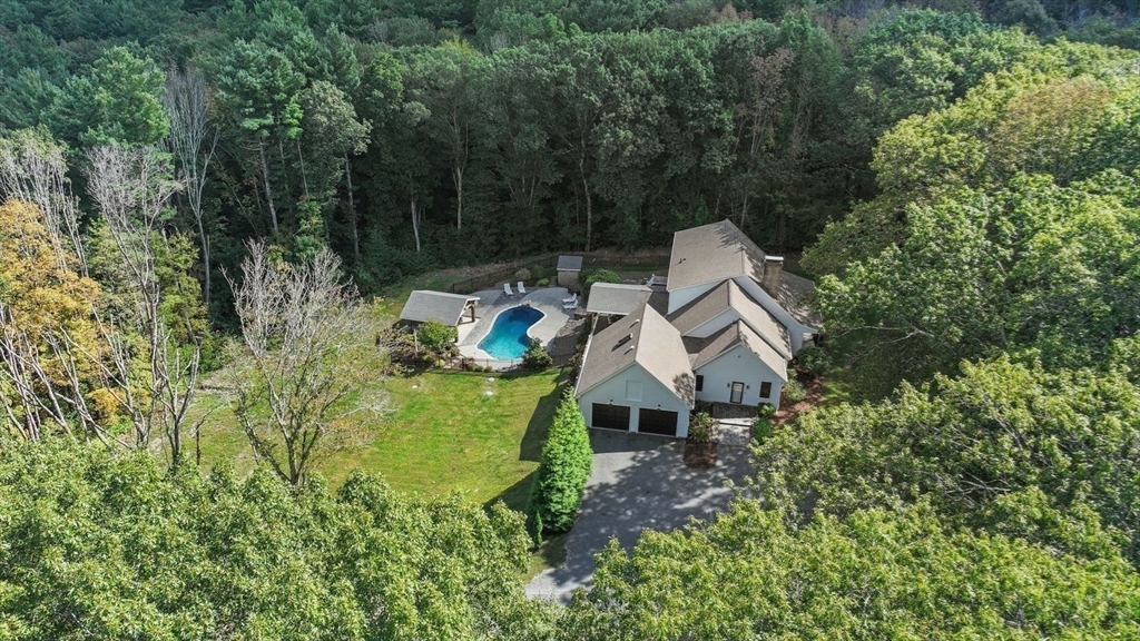 31 Douglas Road Sutton, MA 01590 - Photo 2 of 42 an aerial view of a house with swimming pool and garden