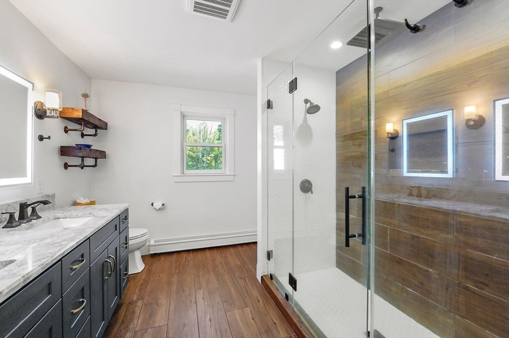 31 Douglas Road Sutton, MA 01590 - Photo 22 of 42 a bathroom with a sink a toilet and shower