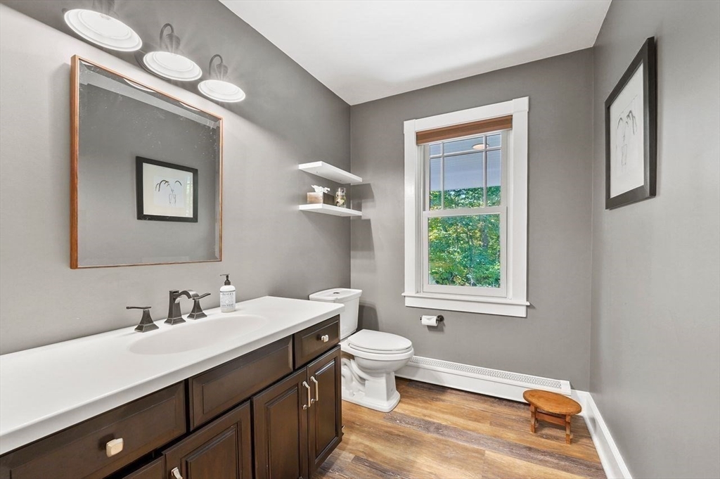 31 Douglas Road Sutton, MA 01590 - Photo 25 of 42 a bathroom with a toilet sink and mirror