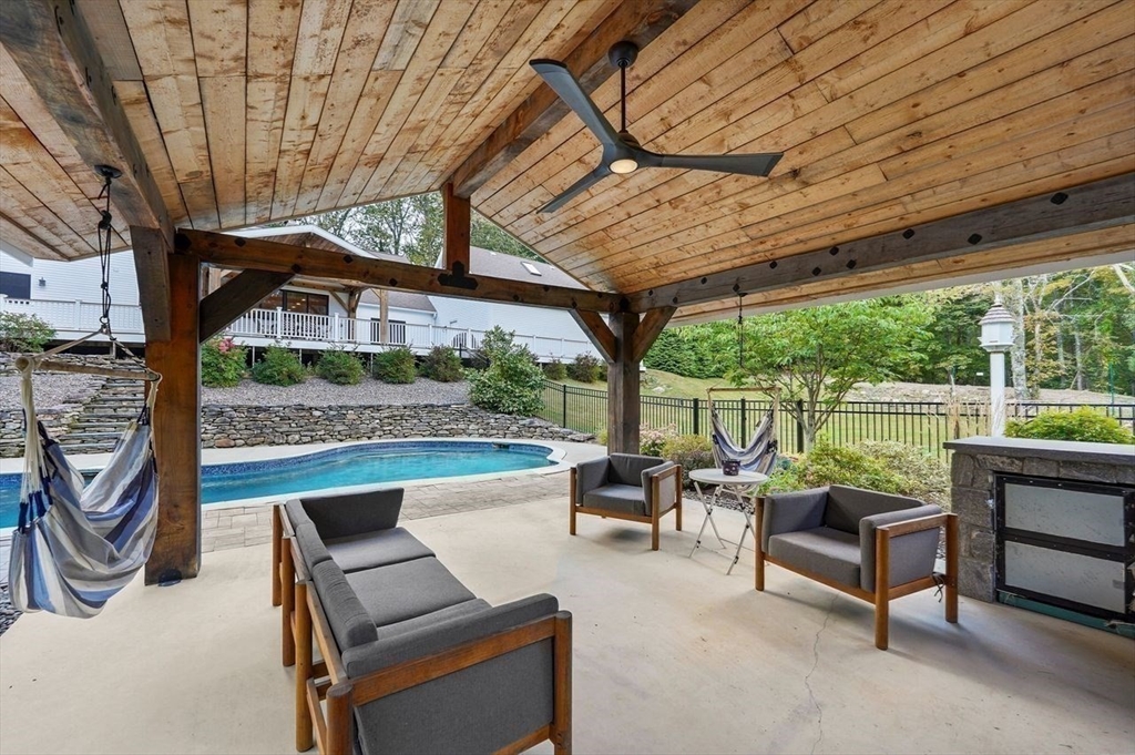 31 Douglas Road Sutton, MA 01590 - Photo 36 of 42 a balcony with furniture and a large tree