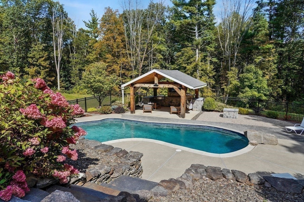 31 Douglas Road Sutton, MA 01590 - Photo 37 of 42 a view of a house with swimming pool and sitting area