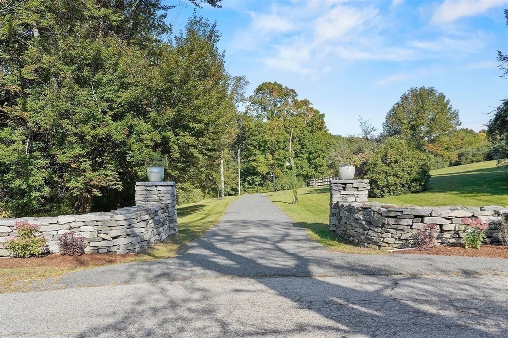 31 Douglas Road Sutton, MA 01590 - Photo 42 of 42 a view of a road with a bench and trees around