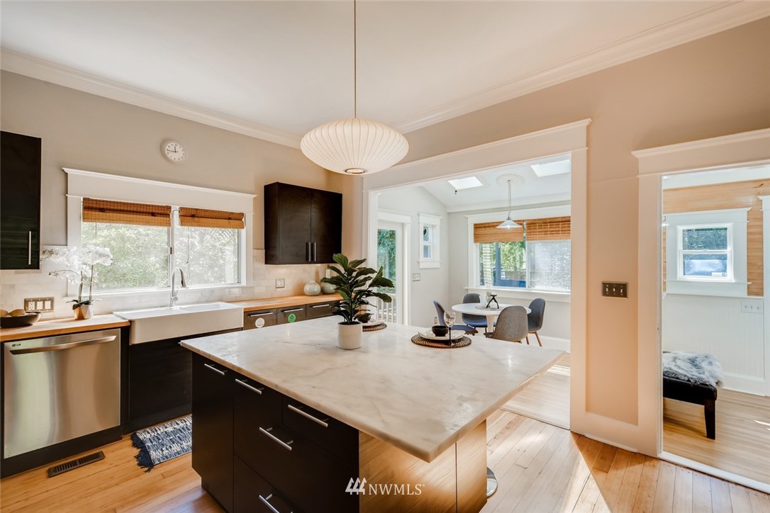 117 24th Avenue Seattle, WA 98122 - Photo 11 of 39 a kitchen with a sink a counter top space and living room view
