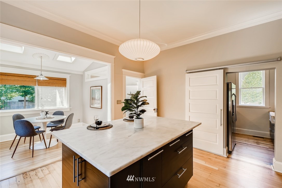 117 24th Avenue Seattle, WA 98122 - Photo 14 of 39 a kitchen with a table chairs and wooden floor