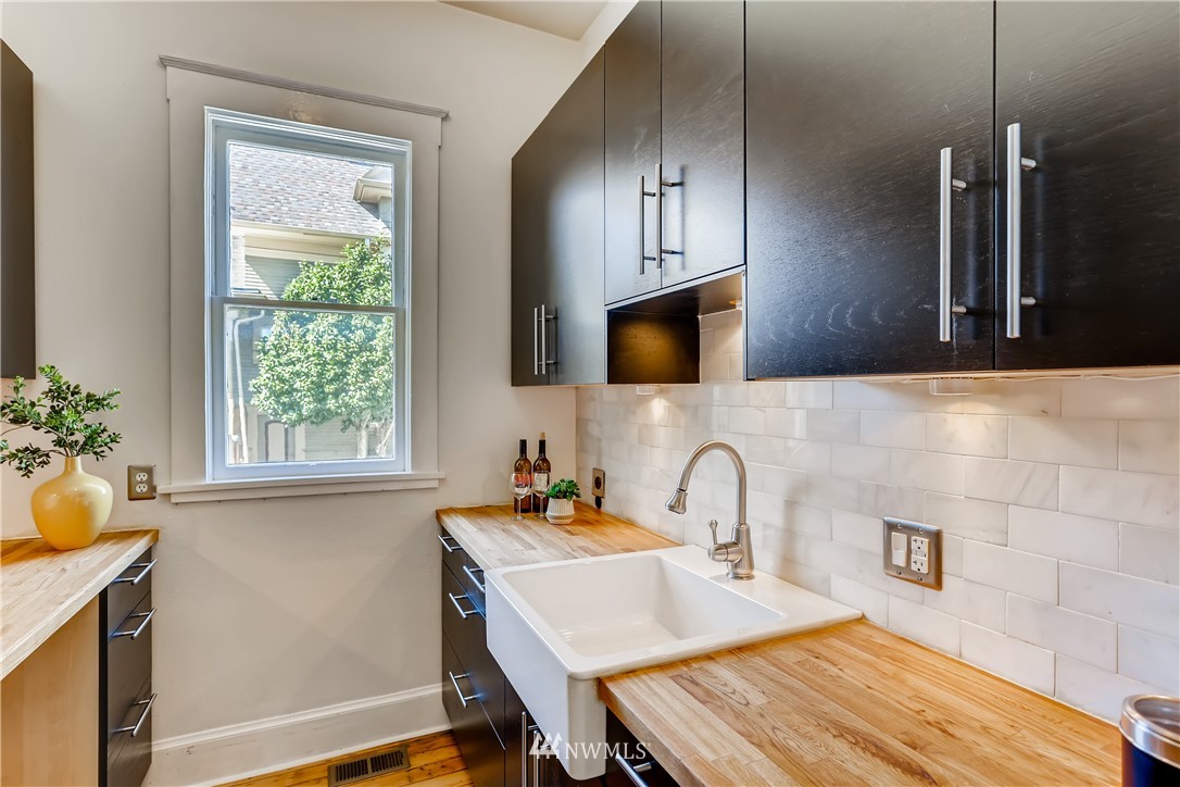 117 24th Avenue Seattle, WA 98122 - Photo 15 of 39 a kitchen with a sink a window and cabinets