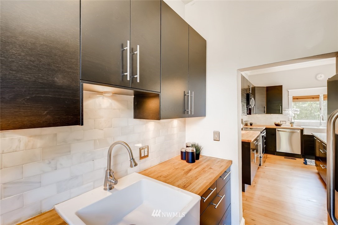 117 24th Avenue Seattle, WA 98122 - Photo 16 of 39 a kitchen with stainless steel appliances kitchen island a sink stove and refrigerator
