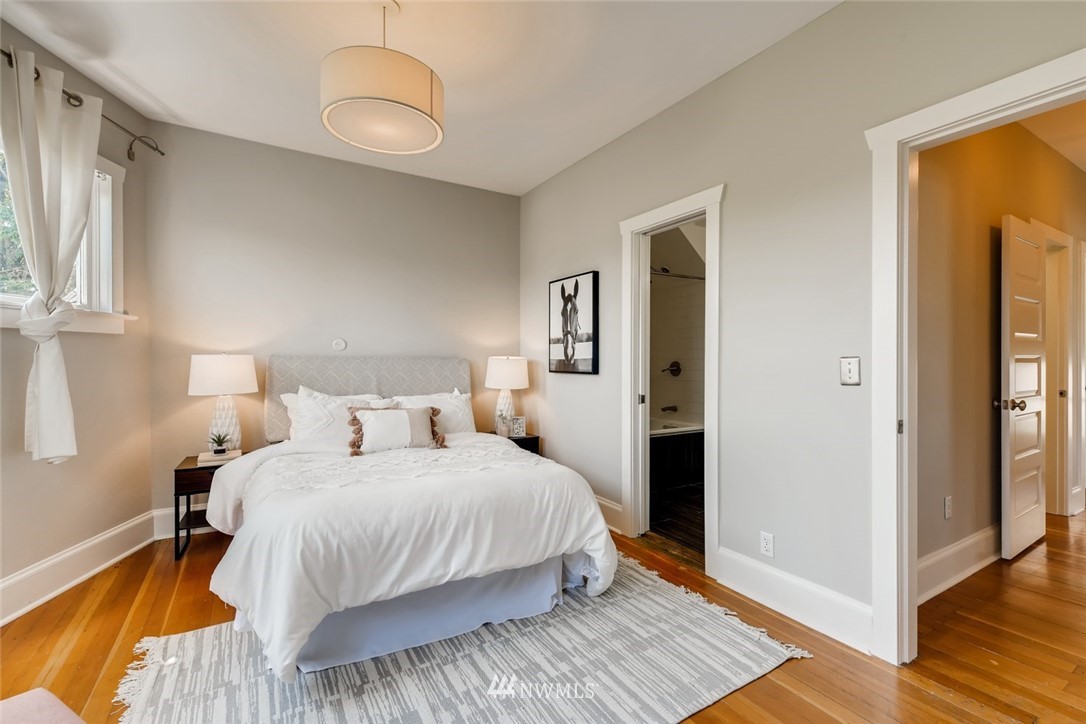 117 24th Avenue Seattle, WA 98122 - Photo 19 of 39 a bedroom with a bed and wooden floor