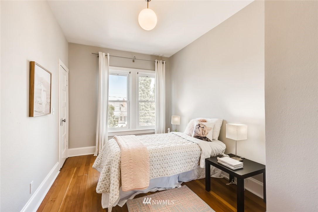 117 24th Avenue Seattle, WA 98122 - Photo 21 of 39 a bedroom with a bed and wooden floor