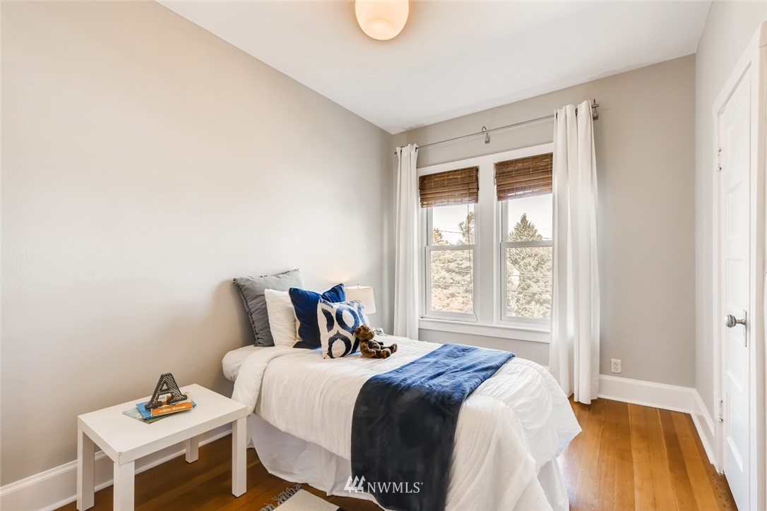 117 24th Avenue Seattle, WA 98122 - Photo 23 of 39 a bedroom with a bed and a window