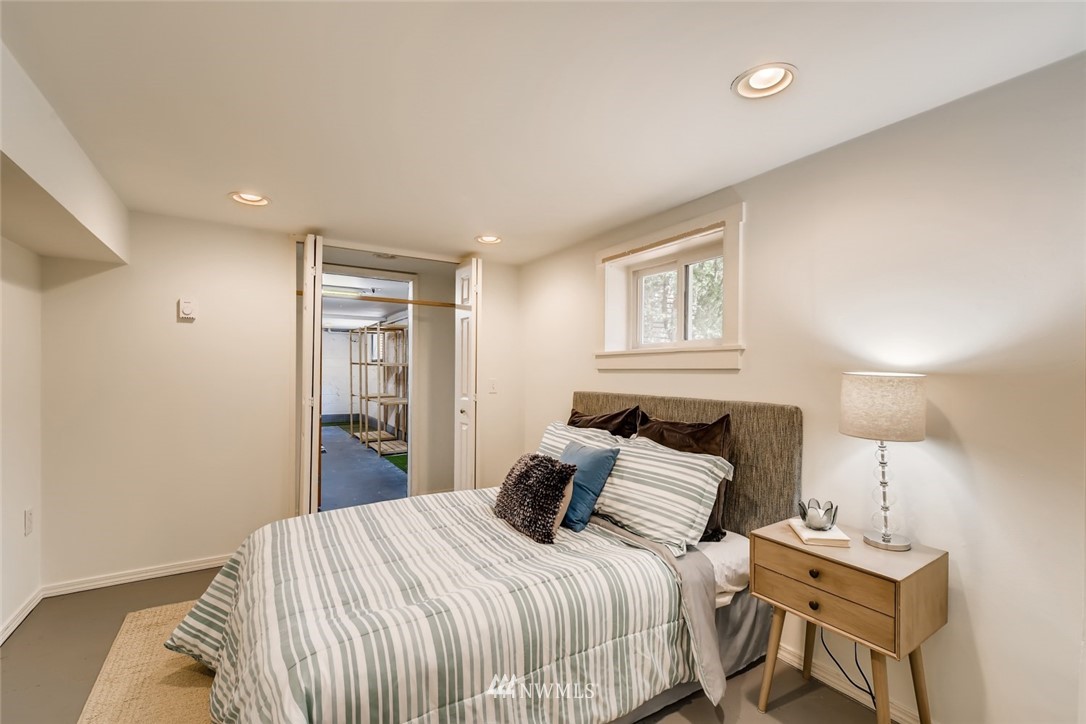 117 24th Avenue Seattle, WA 98122 - Photo 29 of 39 a bedroom with a bed and a night stand