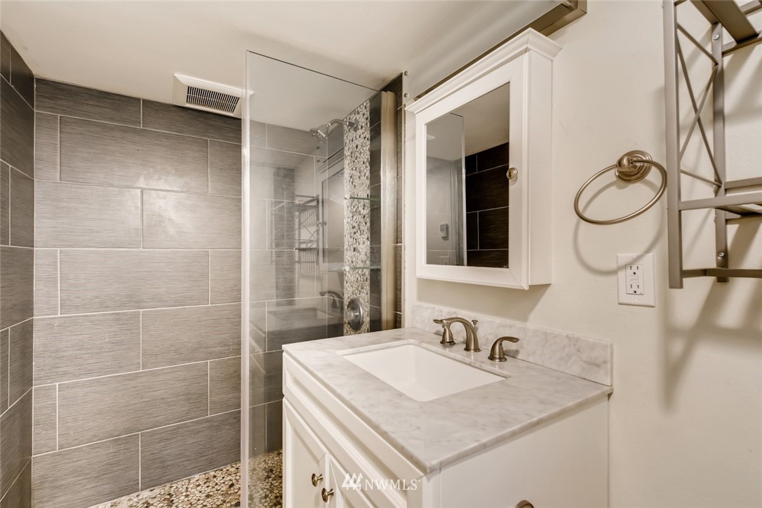 117 24th Avenue Seattle, WA 98122 - Photo 30 of 39 a bathroom with a sink vanity granite and a mirror