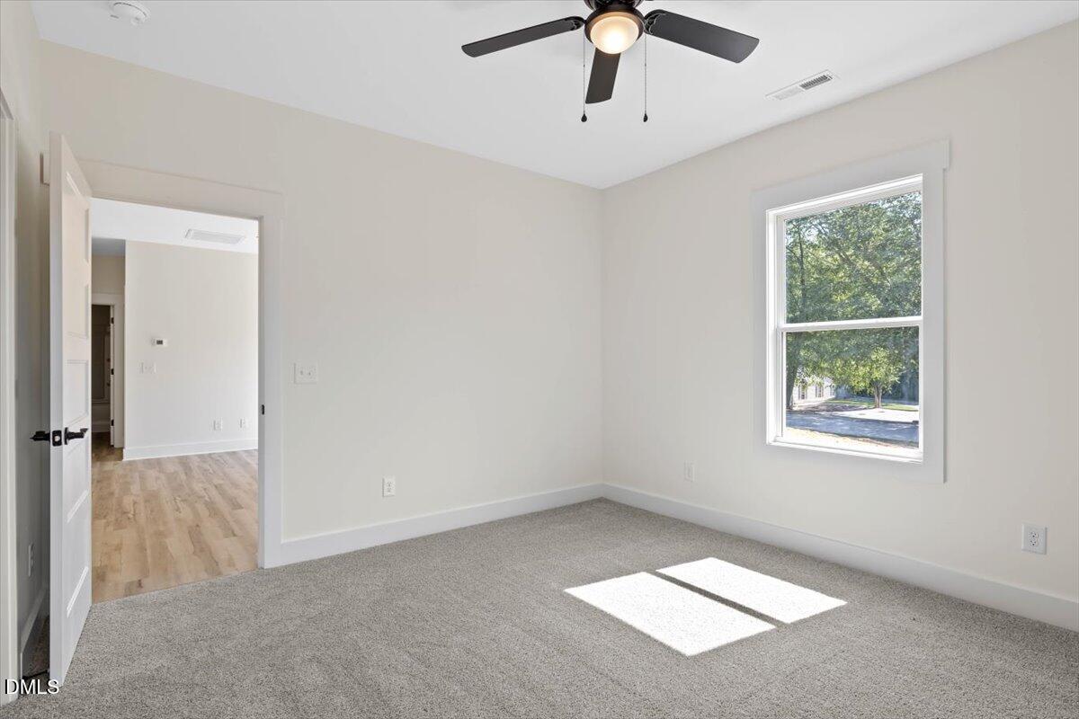 79 Theresia Lane Roxboro, NC 27574 - Photo 21 of 31 en empty room with windows and ceiling fan