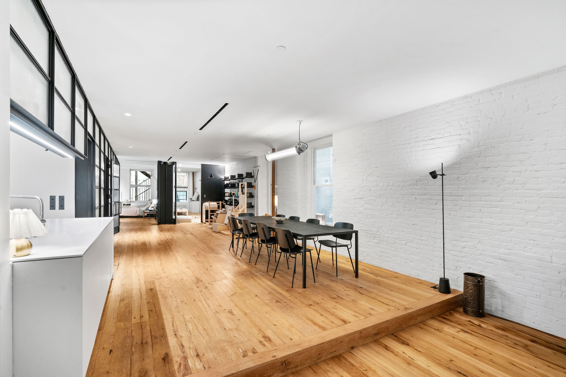 64-66 Grand Street, Unit 5 Manhattan, NY 10013 - Photo 4 of 11 a view of a dining room with furniture and wooden floor