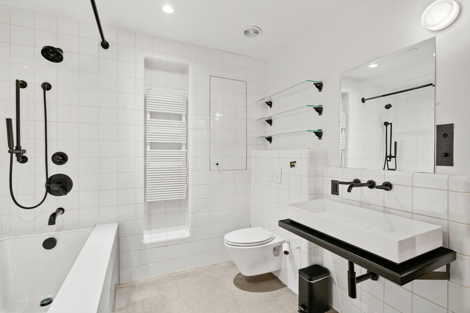 64-66 Grand Street, Unit 5 Manhattan, NY 10013 - Photo 5 of 11 a bathroom with a sink a toilet a mirror and shower