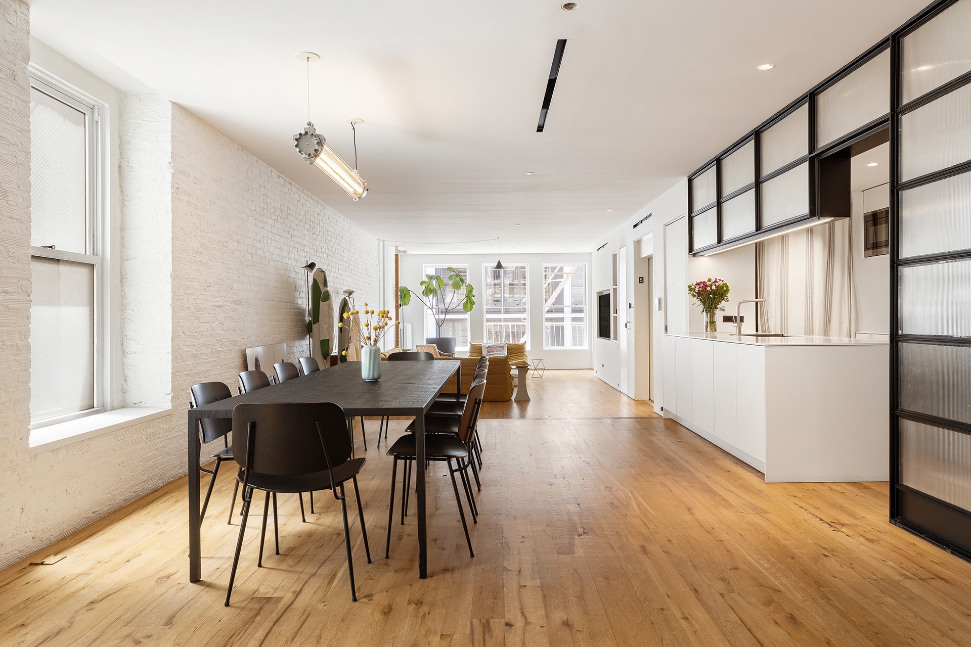 64-66 Grand Street, Unit 5 Manhattan, NY 10013 - Photo 6 of 11 a view of a dining room with furniture and wooden floor