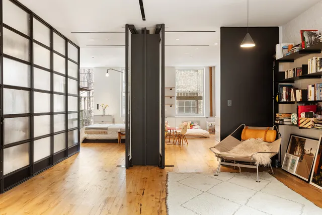 a living room with furniture and a book shelf