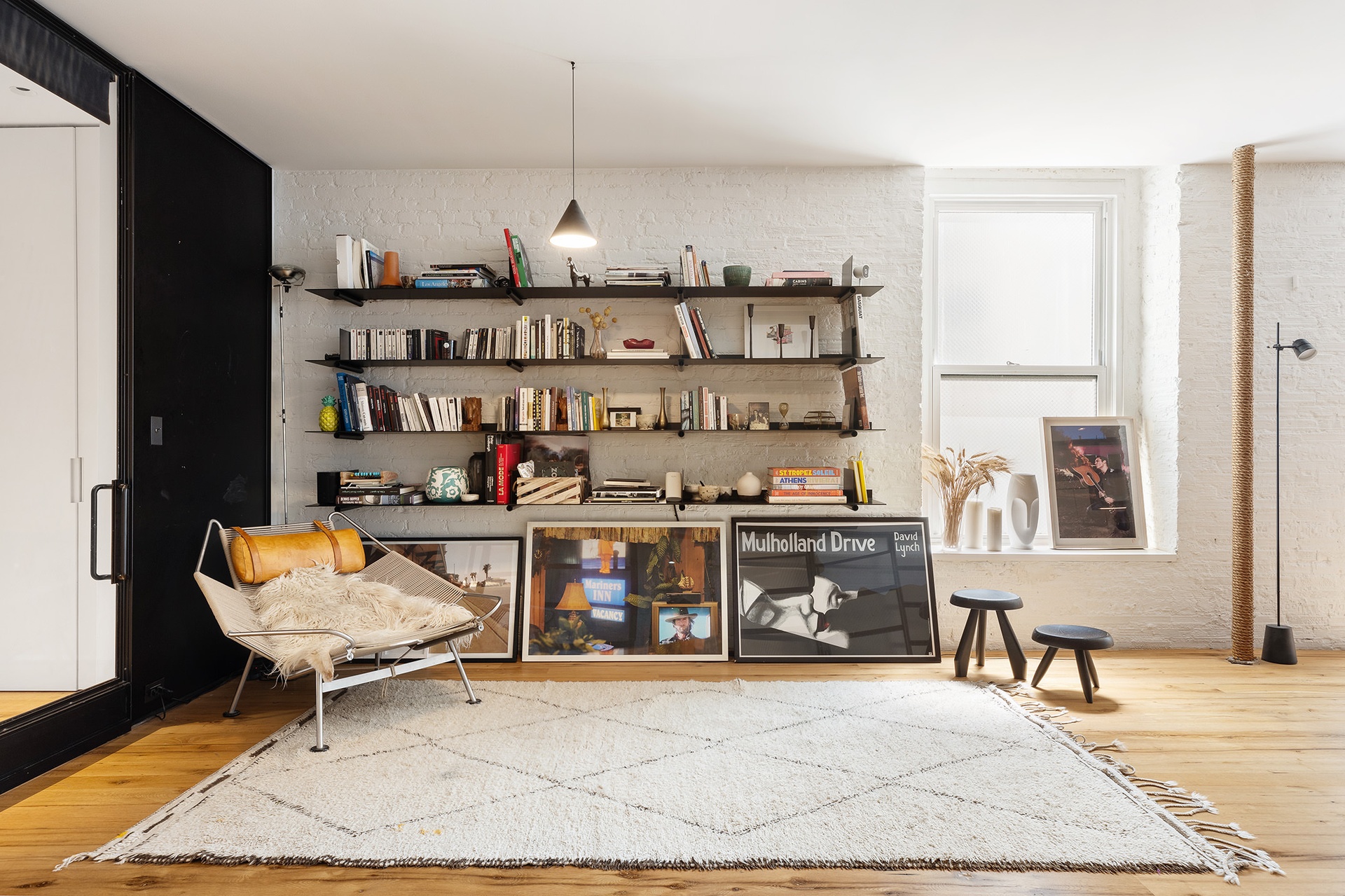 64-66 Grand Street, Unit 5 Manhattan, NY 10013 - Photo 9 of 11 a living room with furniture a rug and a window
