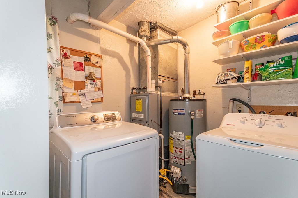 130 Fairview Road Geneva, OH 44041 - Photo 23 of 34 Laundry area featuring gas water heater, laundry area, and washer and clothes dryer