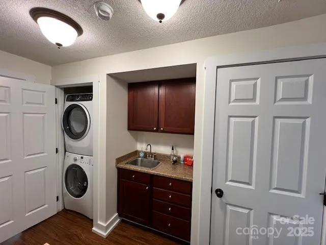 a view of washer and dryer with bathroom in the background