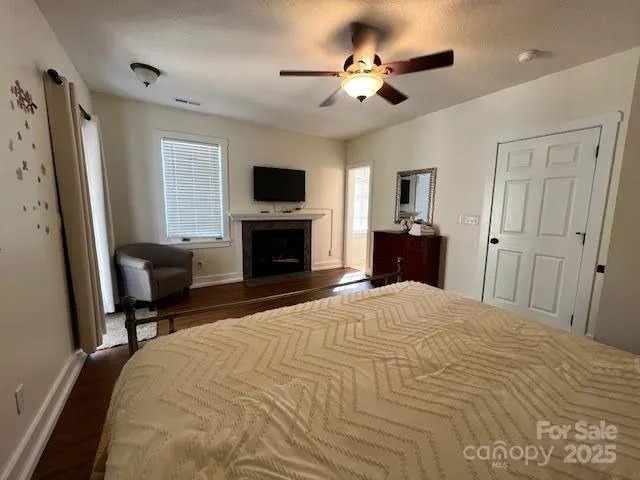a bedroom with a bed flat screen tv and a couch