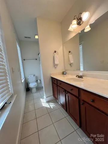 a spacious bathroom with a double vanity sink and a mirror