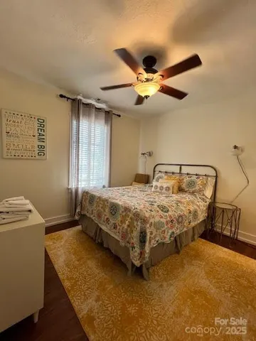 a bedroom with a bed and a ceiling fan
