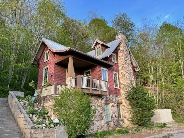 a view of a house with a yard and potted plants