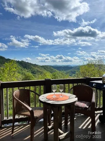 a view of a chairs and table in the balcony