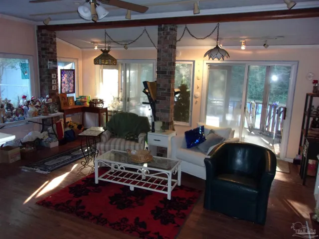 a living room with furniture and wooden floor