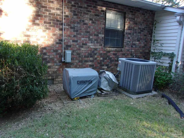 a view of a backyard with plants and outdoor seating