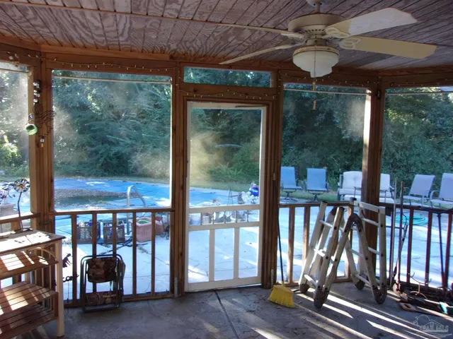 a view of a porch with furniture and front door