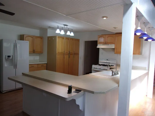 a kitchen with stainless steel appliances a sink refrigerator and microwave