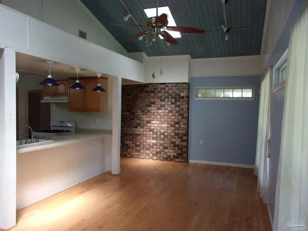 a view of a chair and table in backyard of the house