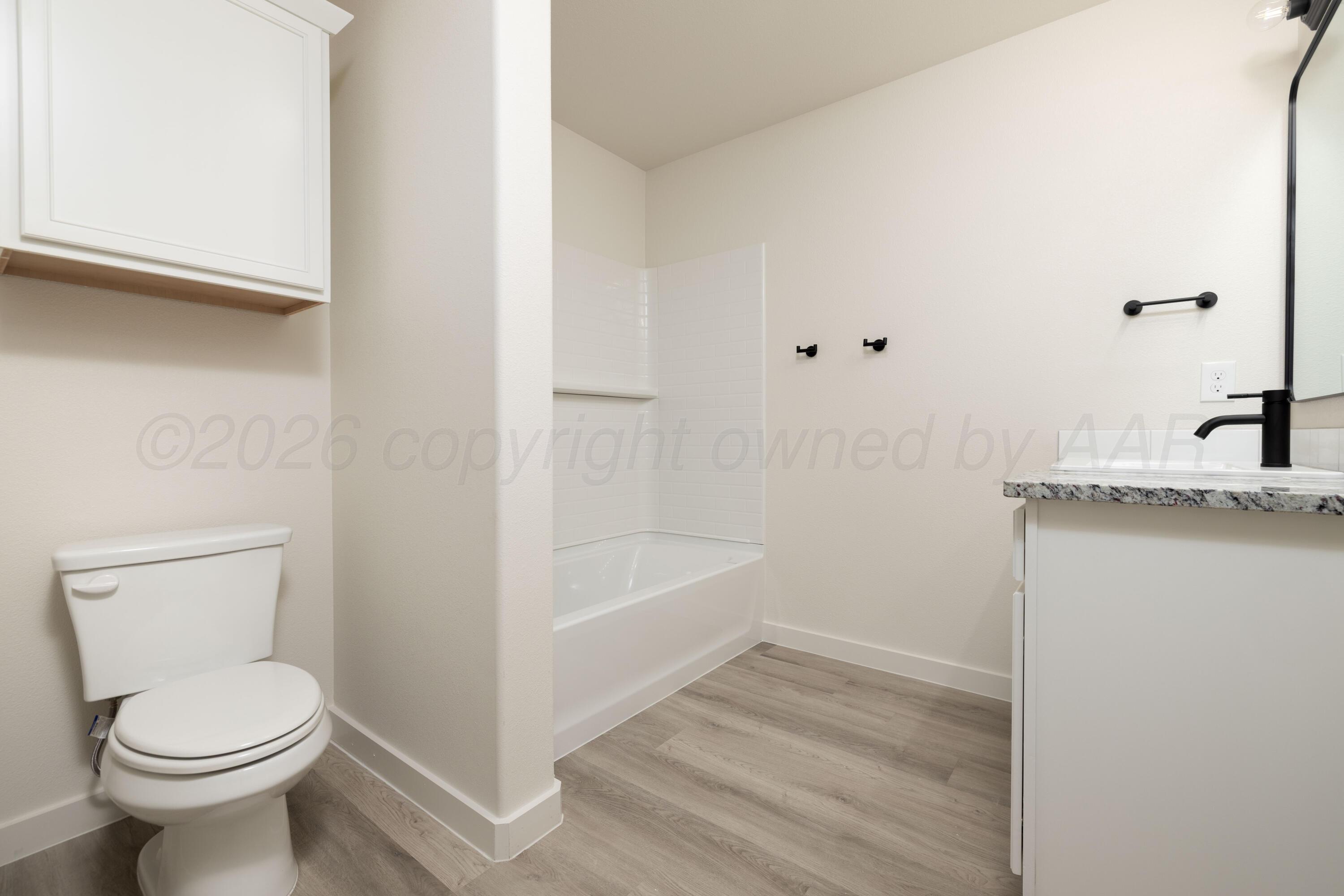 3010 Flycatcher Road Amarillo, TX 79124 - Photo 6 of 11 a bathroom with a sink a toilet and shower