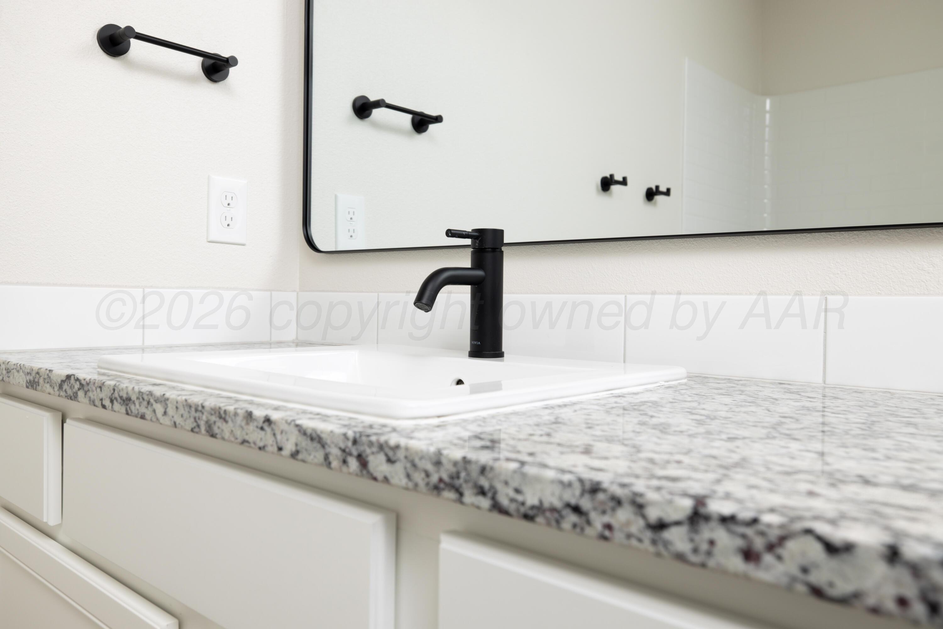 3010 Flycatcher Road Amarillo, TX 79124 - Photo 7 of 11 a bathroom with a sink and a mirror