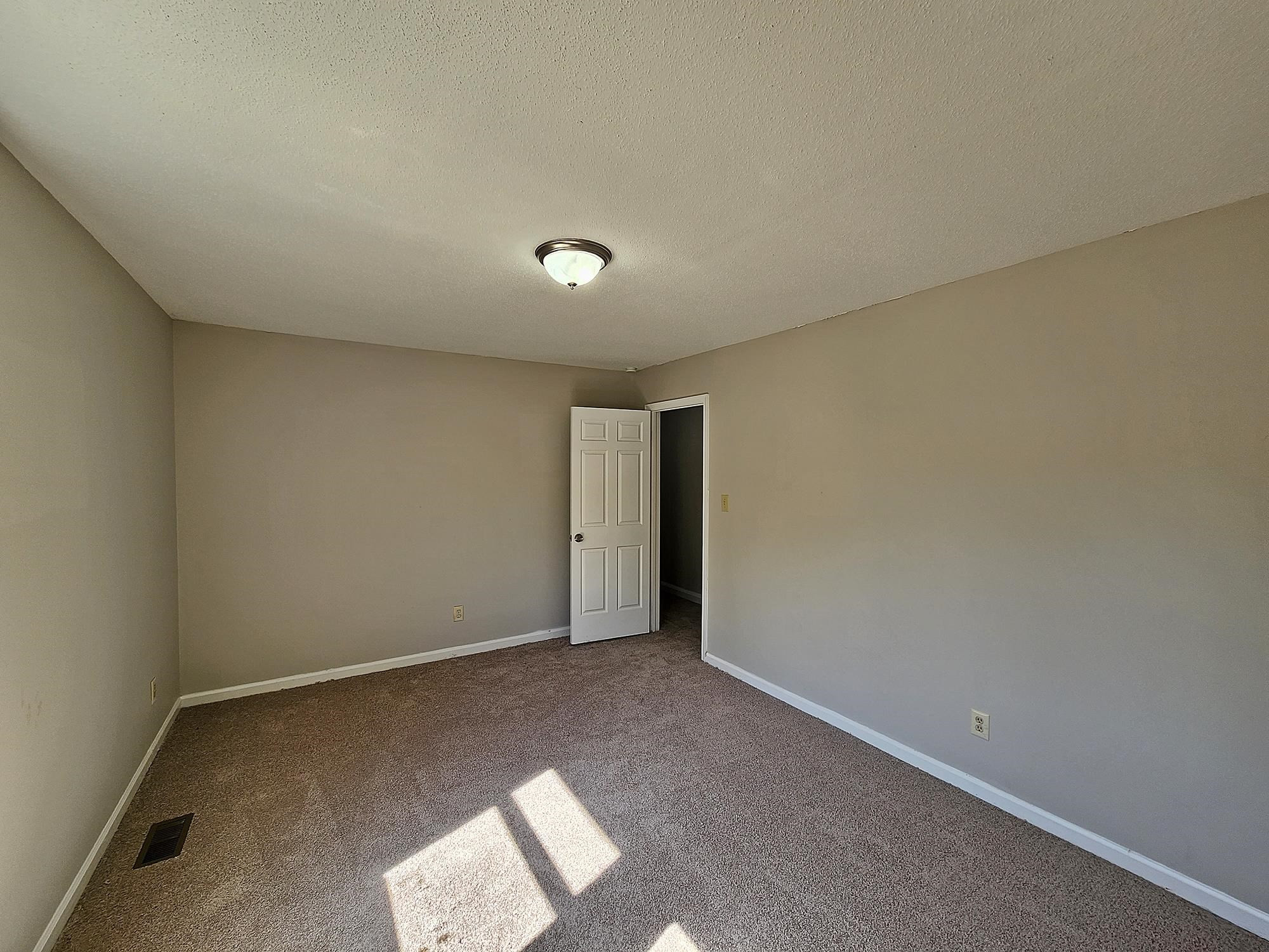 3303 Comstock Road Raleigh, NC 27604 - Photo 17 of 18 an empty room with a natural light