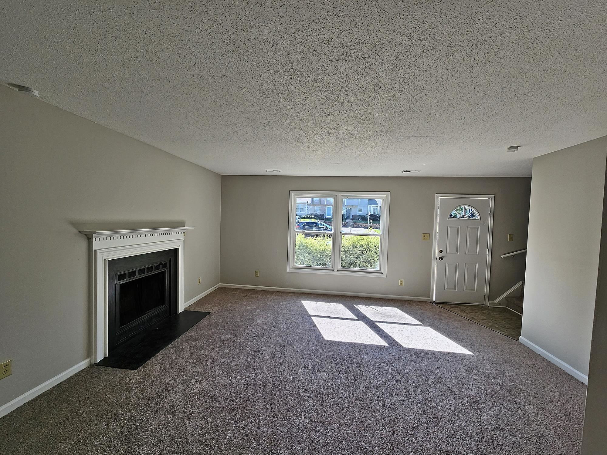 3303 Comstock Road Raleigh, NC 27604 - Photo 8 of 18 an empty room with windows and fireplace
