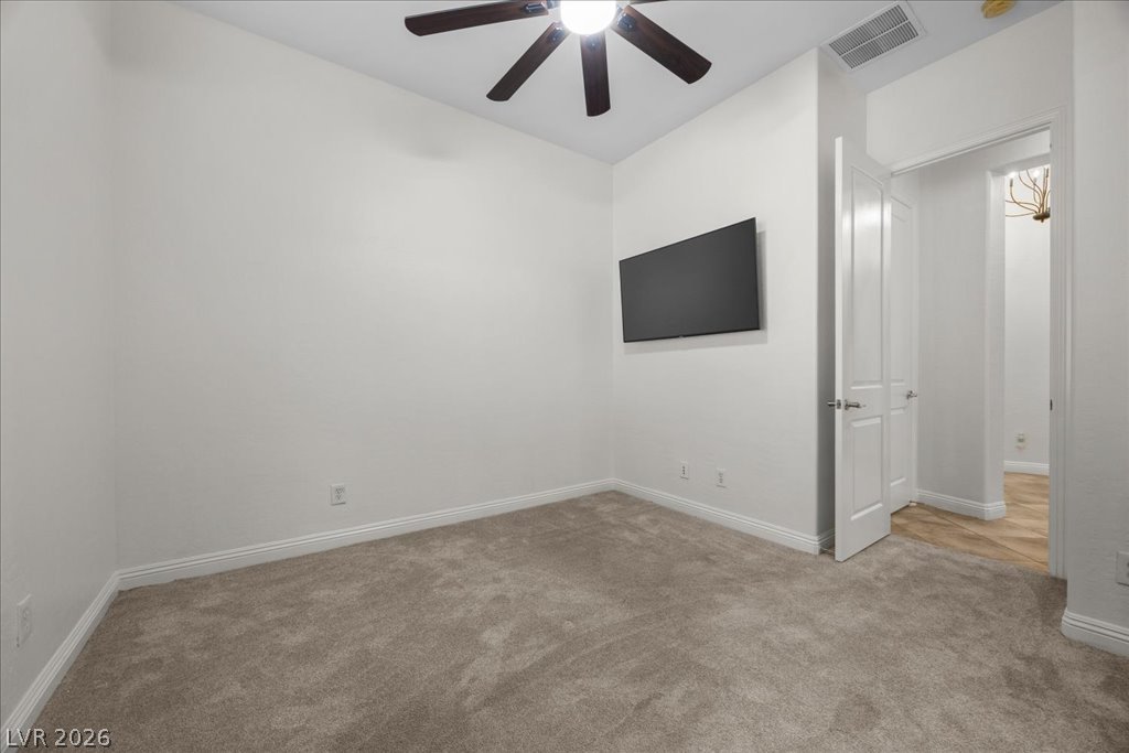 2125 De Rouge Avenue Henderson, NV 89044 - Photo 66 of 96 Well-lit room featuring soft carpeting and a functional ceiling fan.