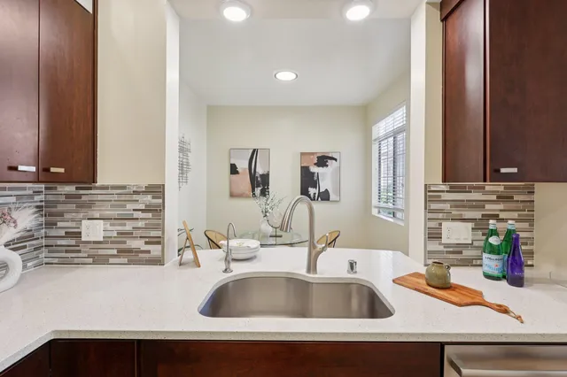 a kitchen with granite countertop a stove and a microwave