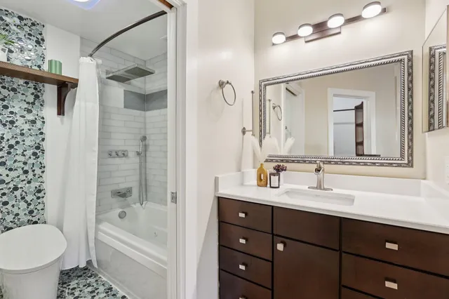 a bathroom with a bathtub and a shower