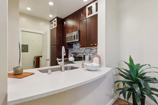 a kitchen with stainless steel appliances a stove sink and cabinets
