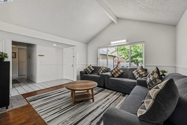 a view of a livingroom with furniture and hardwood floor