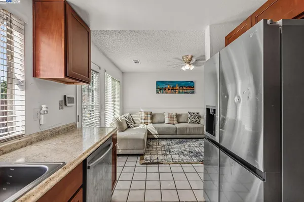 a kitchen with stainless steel appliances granite countertop a sink stove and microwave