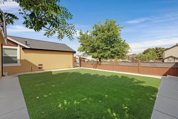 a view of a house with backyard and sitting area