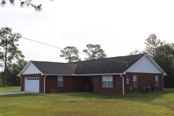 3444 King Lake Road DeFuniak Springs, FL 32433 - Photo 1 of 29 a front view of a house with a garden