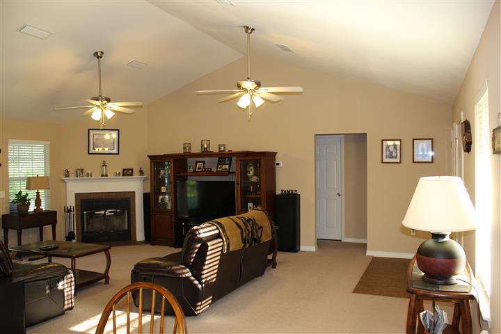 3444 King Lake Road DeFuniak Springs, FL 32433 - Photo 11 of 29 a living room with furniture a chandelier and a window