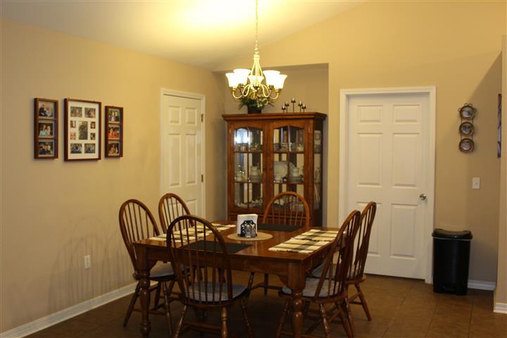 3444 King Lake Road DeFuniak Springs, FL 32433 - Photo 13 of 29 a view of a dining room with furniture and chandelier