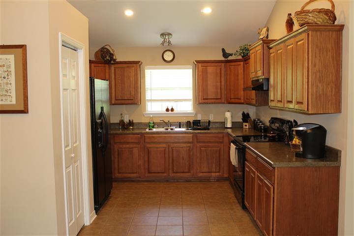 3444 King Lake Road DeFuniak Springs, FL 32433 - Photo 15 of 29 a kitchen with stainless steel appliances granite countertop a stove a sink and a refrigerator