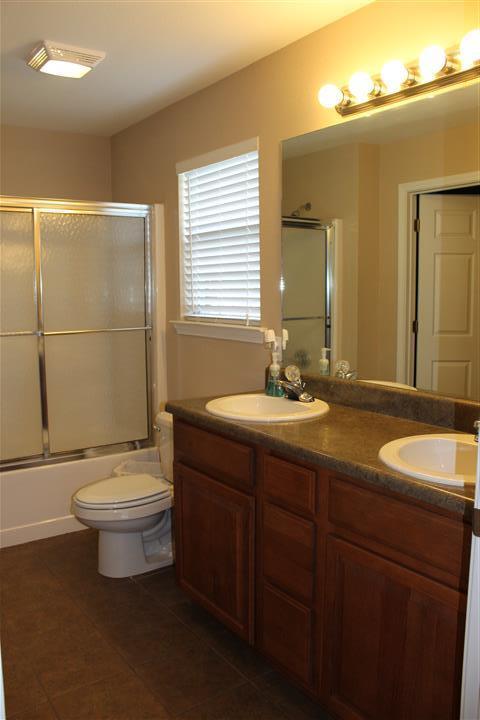 3444 King Lake Road DeFuniak Springs, FL 32433 - Photo 18 of 29 a bathroom with a double vanity sink toilet and a mirror