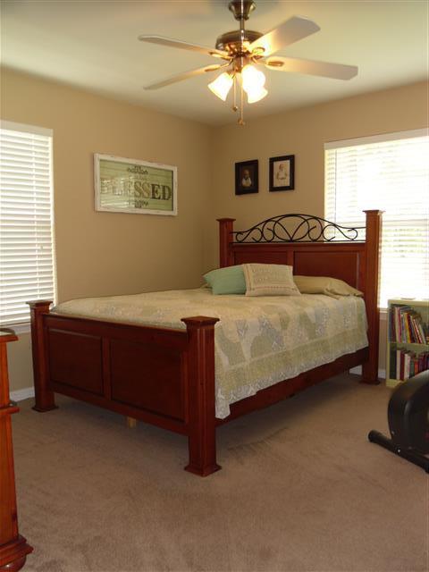 3444 King Lake Road DeFuniak Springs, FL 32433 - Photo 19 of 29 a bedroom with a bed and a chandelier